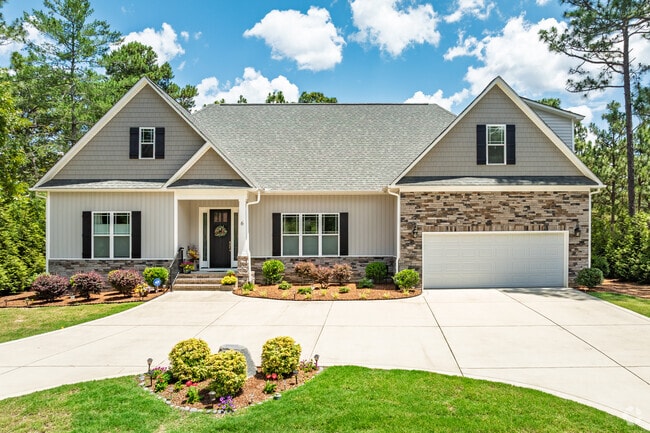 A New Traditional home in Pinehurst boasts clean landscaping and modern curb appeal.