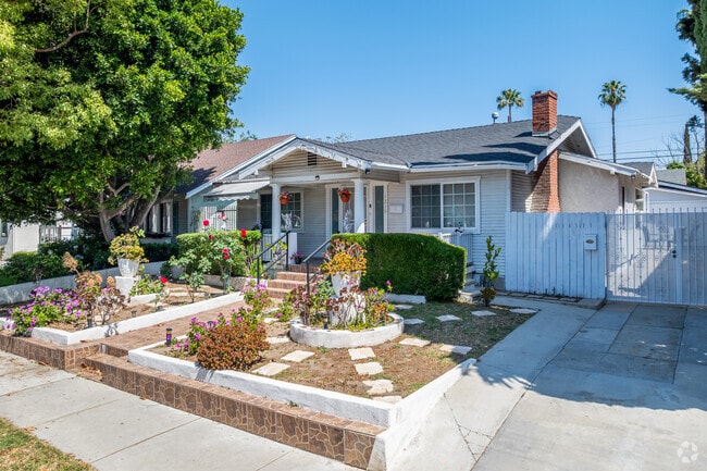 This Citrus Grove home features elaborate landscaping with vibrant flower beds and carefully trimmed hedges that frame the front yard.