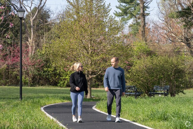 Residents of Windy Hills stroll the newly constructed walking path at Windy Hills Green park.