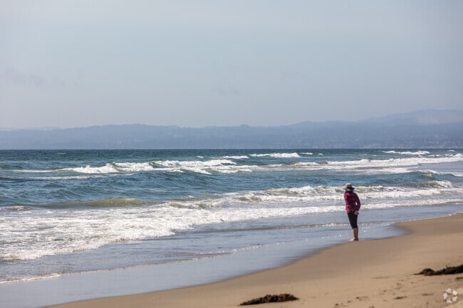 A woman stops to catch the sea breeze in Pajaro Dunes, enjoying the coastal air.