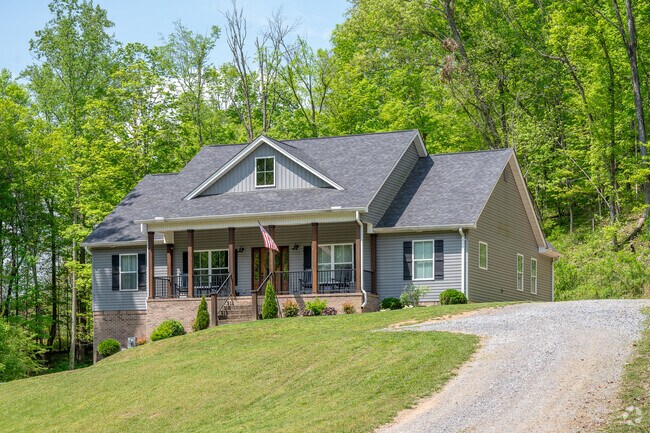A contemporary Craftsman cottage stands along a hill abutting Long Hollow Road in Sullivan Gardens.