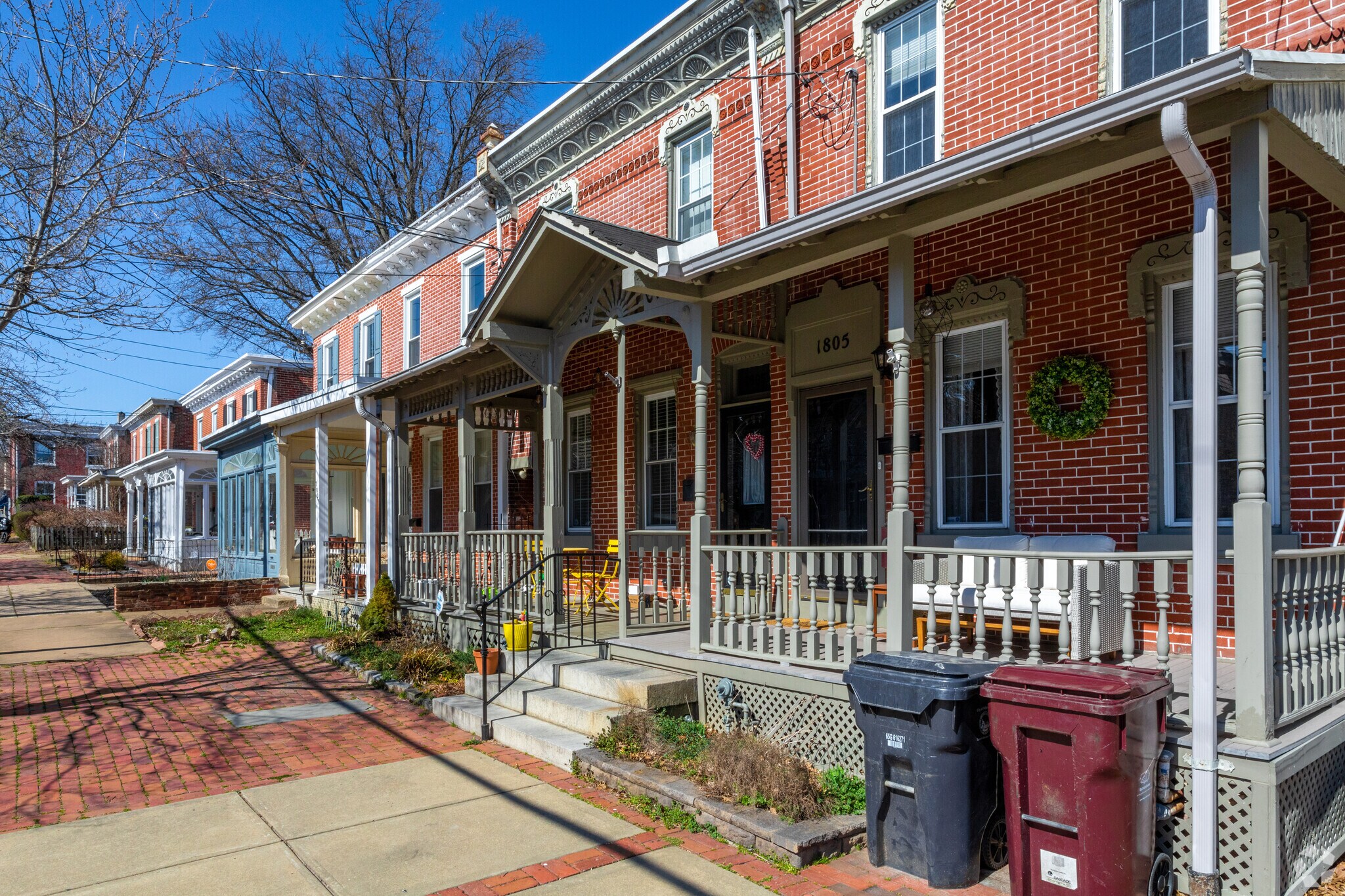 A row of townhomes with front porches located in the Highlands neighborhood.
