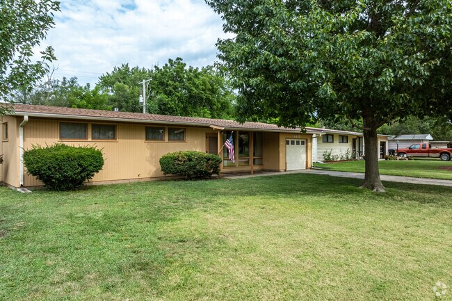Large stretching front lawns lead to ranch homes with one car garages inLikins Foster.