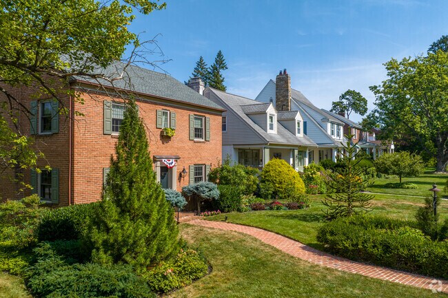 Brick colonial revivals in Violet Hill feature colored shutters.
