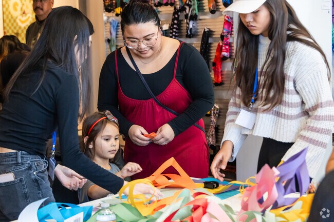 Families learn paper parol making at the Long Beach Parol Lantern Festival.