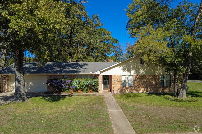 Tree-lined front yards are common in Pines Road.