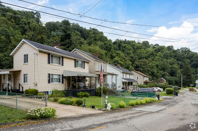 Rows of homes line the streets of Hays surrounded by the green backdrop of trees.