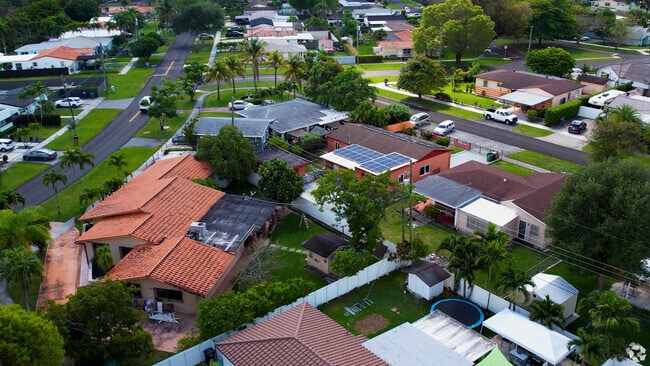 Lush lawns and native flora surround South Miami's residential streets.