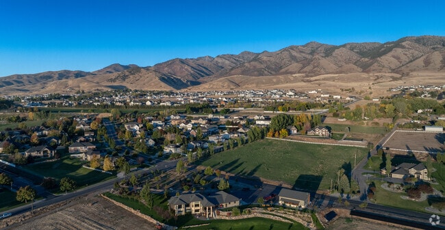 Hyde Park, where peaceful neighborhoods sit at the base of rugged mountain slopes under the evening light.