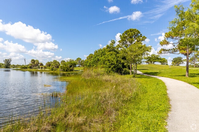 A serene walking trail hugs the lake inside Okeeheelee Park.