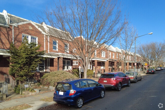 Brick facade row homes line a block in Langston.