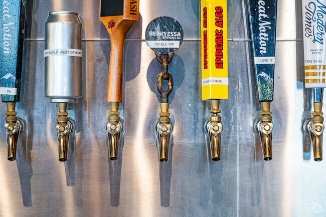 Brass taps line the bar in Leisure Town at The Brass Tap.