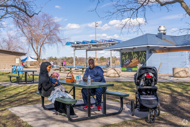 A family enjoys the picnic area at Lake Nokomis Beach.