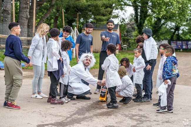 Kids participate in a science demonstration at The Lighthouse in Fairhill.