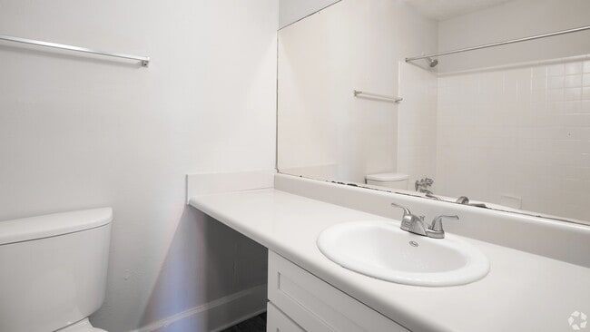 Guest bathroom featuring a spacious countertop, modern fixtures, and a large mirror for added convenience.