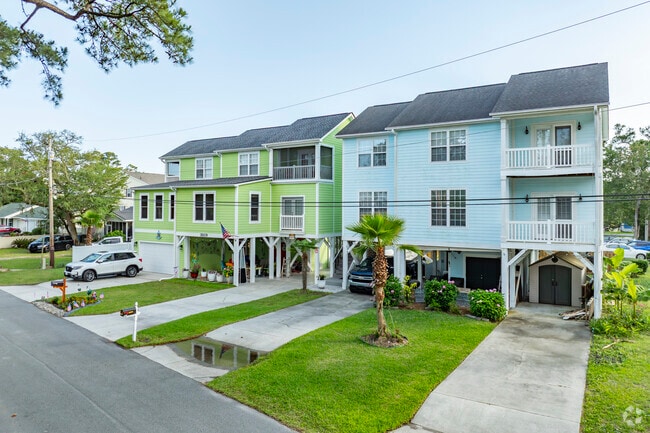 Surfside Beach features stilted homes designed for coastal living, offering protection from tides while embracing scenic ocean views.