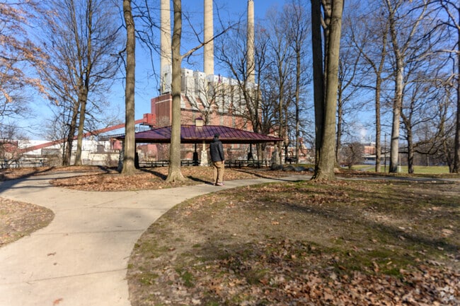 A man walks past Lansing's Eckert Power Plant in Moores Park.