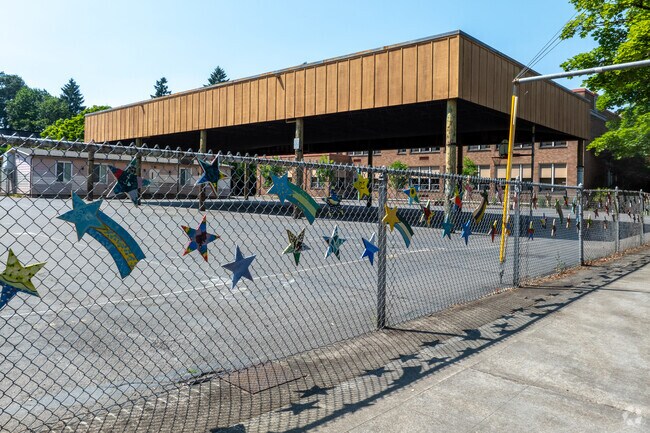 Fence decorations at flare to Llewellyn Elementary on SE 14th Ave in Portland.