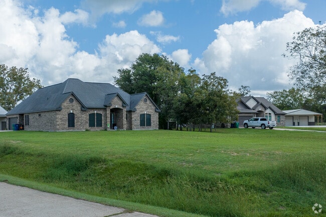 A four bedroom home sits on a large plot of land in Angleton, Texas.