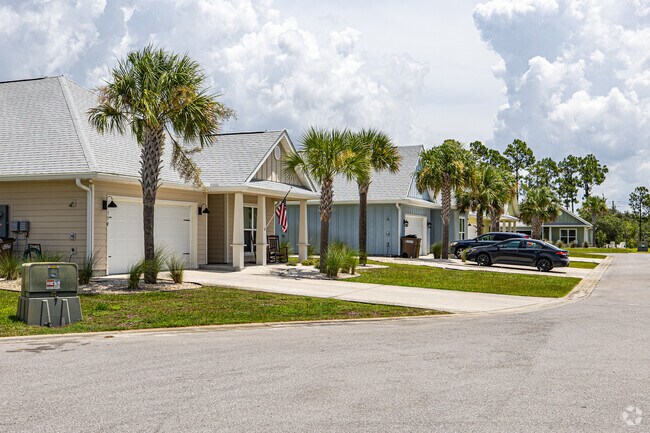 This quiet street of single-family homes highlights the architectural simplicity and natural beauty valued in Indian Pass communities.