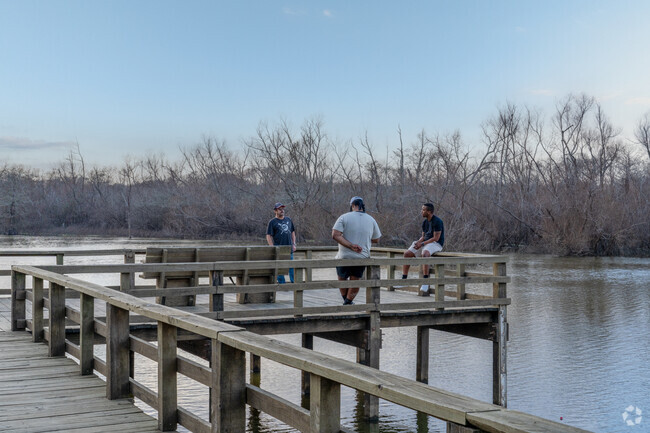 Locals gather at the fishing pier in the Trinity River National Wildlife Refuge to enjoy the day.