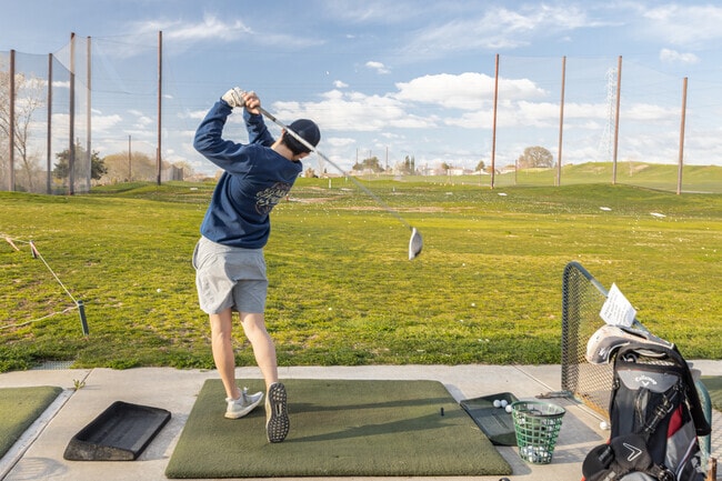 Golfers work on their form at the Empire Ranch Golf Club driving range.