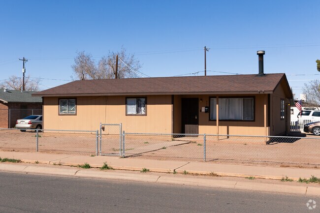 Older Ranch-style homes in Downtown Winslow are separated by usually metal fences.