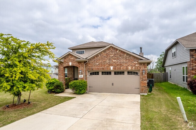 Brick single-story home with a two-car garage in Selma, TX.