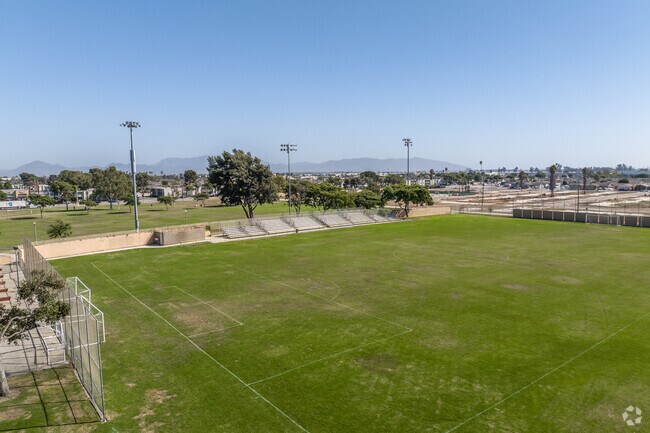There is a soccer field with stadium seating at Del Sol Park in the La Colonia neighborhood.