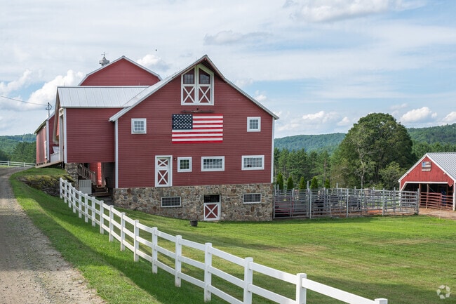 A patriotic barn rests in the hills of Hartland.