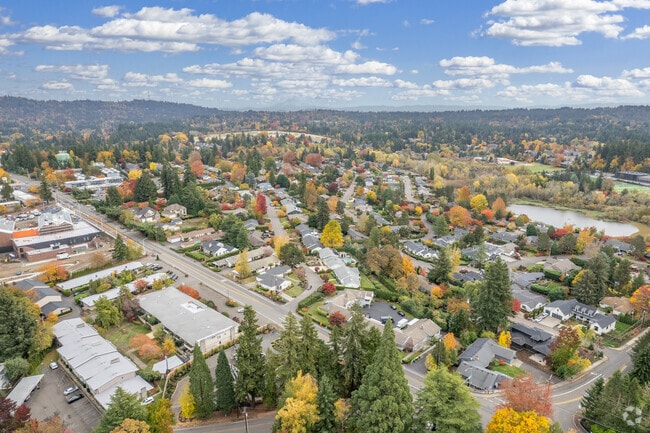 Raleigh Hills neighborhood surrounded by lush greenery and vibrant fall colors with homes near local amenities.