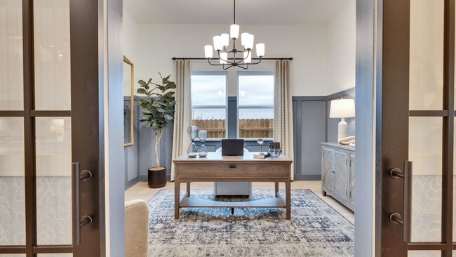 Exquisite home office with French doors, chic chandelier, and serene palette in Spring Creek, Texas.