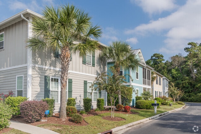 Colorful townhomes in Litchfield Beach offer low‑maintenance living from $200k to $500k.