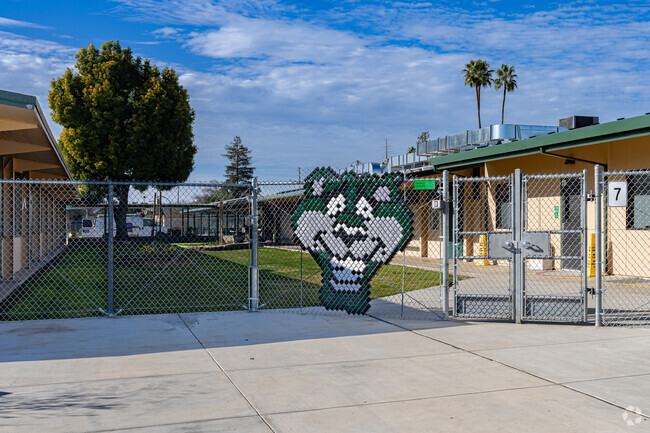 A large fence sign shows the Palm Elementary School panther mascot.