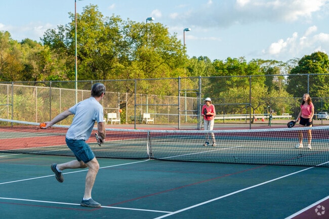 Folks play pickleball at the Montpelier Recreational Area tennis courts near The Meadow.