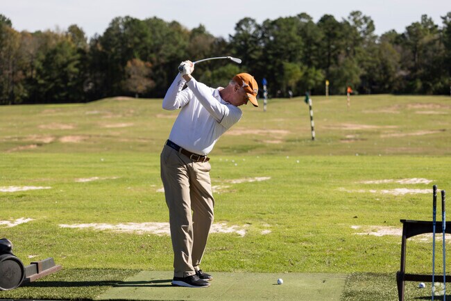 Golfers at Lake Wincrest Golf Club can practice their swings at the driving range in Pinehurst.
