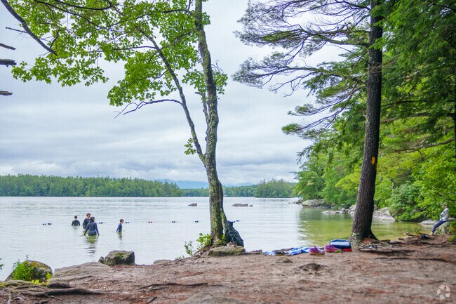 You can enjoy a swim in Squam Lake even on a cloudy day in Center Harbor.