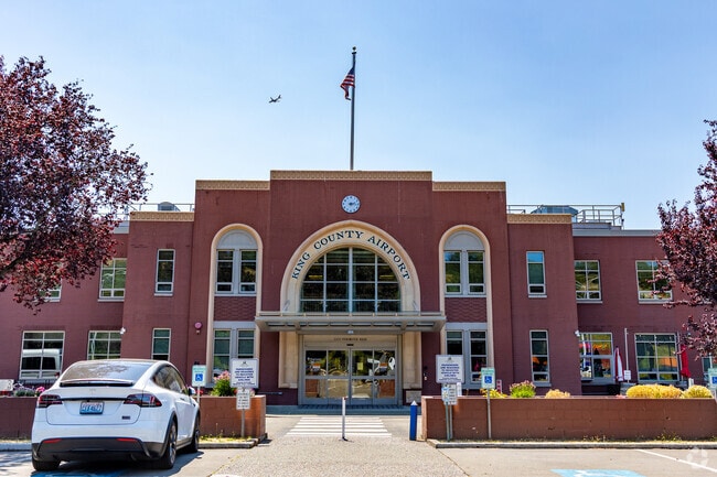 Planes descend over the skyline as they approach King County International Airport–Boeing Field.