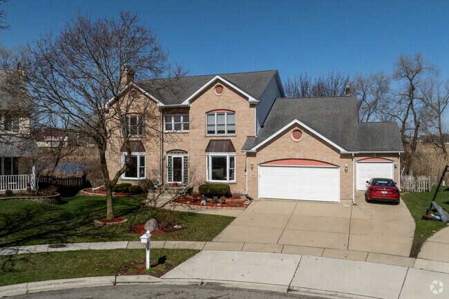 Brick Colonial Revival home style with attached garage is located in Hoffman Estates.
