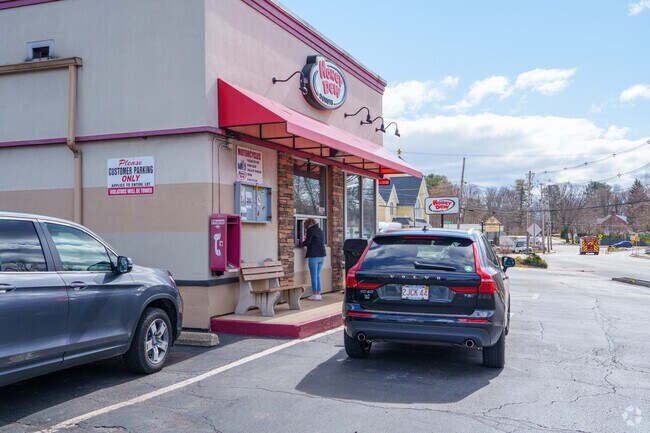 Lakeside residents take advantage of the walk-up window outside Honey Dew Donuts for their coffee and sandwiches.
