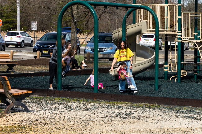 Parents playing with their kids at the playground in Long Bridge Park.