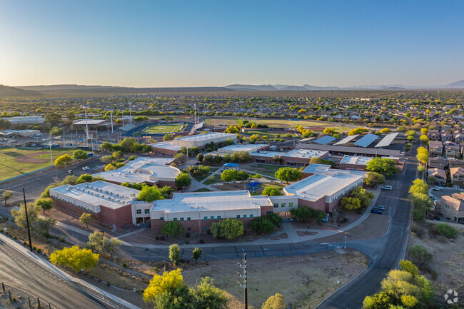 School buildings at Sahuartia High School are surrounded by residential neighborhoods and desert scenery.