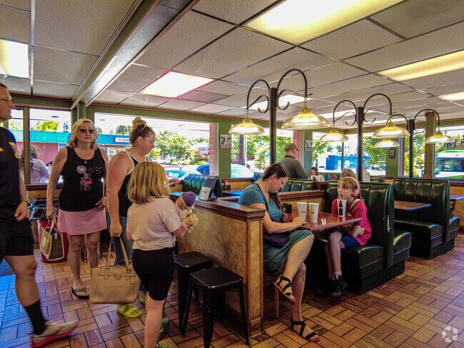 A family enjoying their meal at 5th on 4th Burgers.