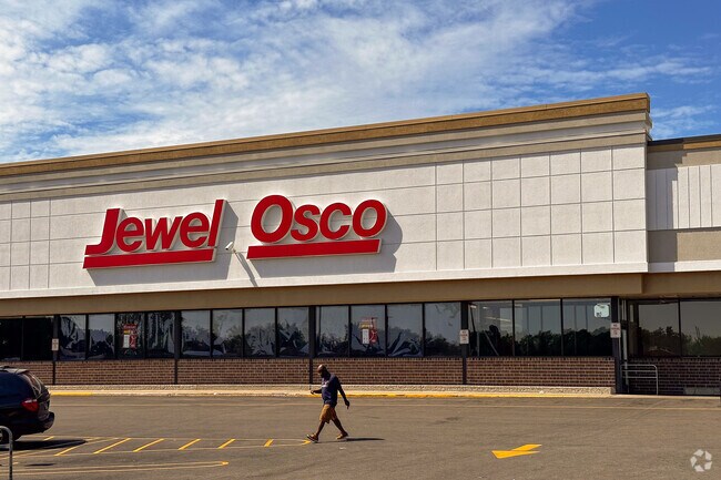 A man walks out of a Jewel Osco near Central Zion.