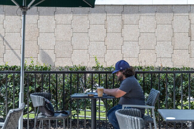 Savoring coffee alfresco, residents work at Meadows Place cafes.