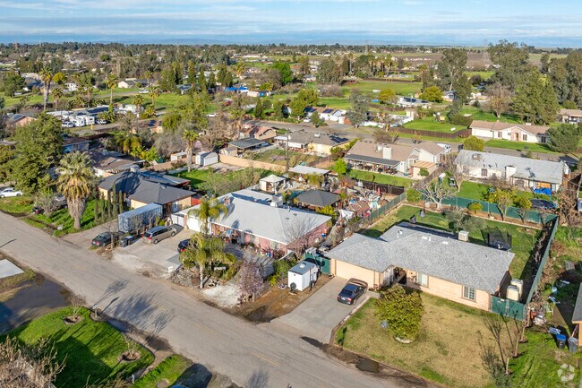 Madera Acres features quiet residential streets set against views of farmland and the Sierra Nevada mountain range.