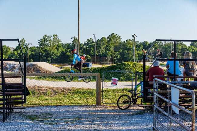 Spectators watch as BMX riders prepare to race at Spokes BMX race track in Ewing.