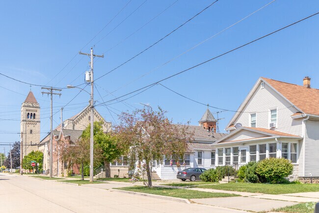 Homes near the steeple enjoy a Sacred Heart backdrop of bells and brick.