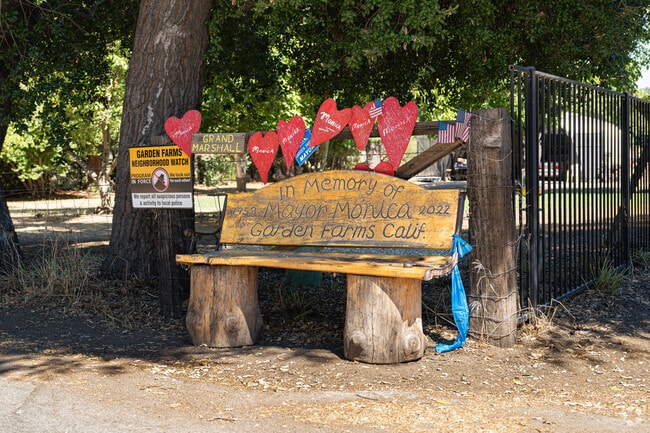 A beautifully hand-carved bench adds character to the homes of Garden Farms.