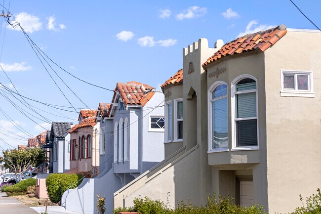 A row of neat and tidy Mediterranean houses line this street in Sign Hill.